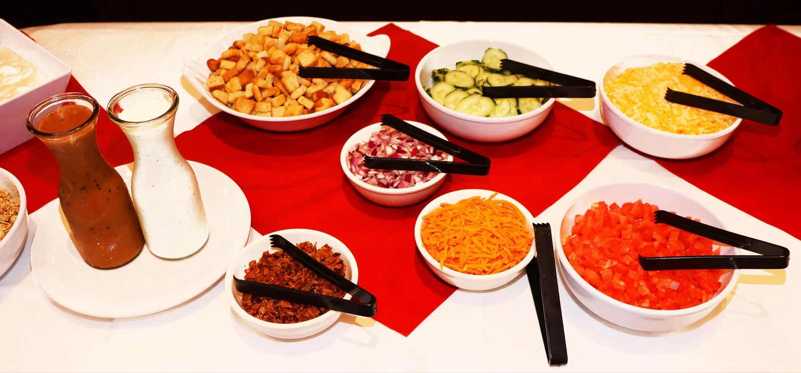 Sunday brunch salad bar with dressings, croutons, cucumbers, cheese, and tomatoes at The Venue Clermont